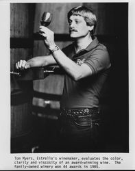 Tom Myers, Estrella's winemaker, evaluates the color, clarity and viscosity of an award-winning wine, Paso Robles, California, 1986