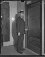 John C. Porter standing in front of the Grand Jury entrance, 1928-1933