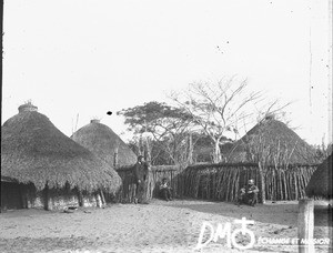 Swiss missionaries in front of huts, Mozambique, ca. 1896-1911