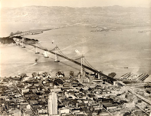 [Aerial view of San Francisco waterfront, Yerba Buena Island and the Bay Bridge looking east]