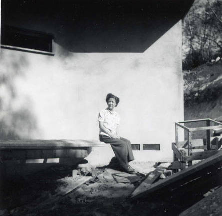 A woman sitting among the construction in progress at the family house (Spencer Chan Family)