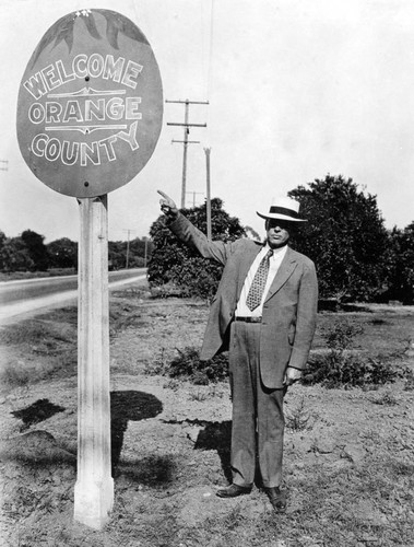 County Supervisor William Schumacher with "Welcome to Orange County" sign