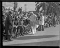 Food vendor selling crispettes pop corn confection to spectators on the route of the Tournament of Roses Parade, Pasadena, 1932