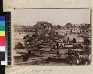 Figures crossing a bridge of boats, Chaozhou, Guangdong Province, China, ca. 1888-1906