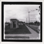 Small pavilion, presumably a real estate office, advertising the Fremont Tract stands in an empty corner lot in the Allendale district of Oakland, California. Newly built homes in view