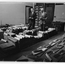 View of Frank Christy of the Sacramento County Historical Society and Jack Rankin, a Sacramento County Highway Engineer compile lists of volumes and documents found in the old Sacramento County Pound