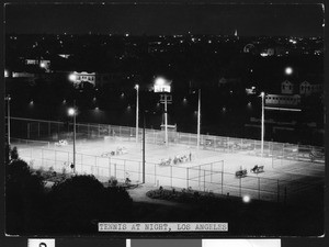 Lit tennis court at night, ca.1940