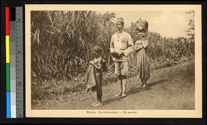 Man, woman, and child out walking, Congo, ca.1920-1940