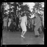 Luci Baines Johnson dancing the Watusi with actor Steve McQueen at Young Citizens for Johnson barbecue in Beverly Hills, Calif., 1964