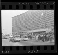 Crowd (including protesters) gathers outside of Century Plaza Hotel in anticipation of President Johnson's arrival, 1967