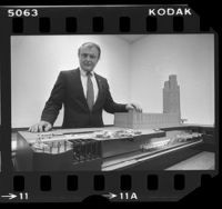 Rapid Transit District manager, John Dyer posing with model of Wilshire and Western Metro Red Line subway station in Los Angeles, Calif., 1984