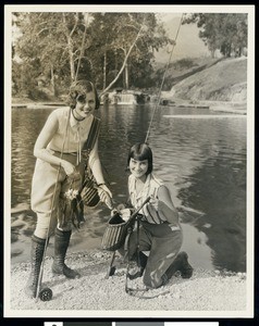Two women holding their trout catch at Rainbow Angling Club, Azusa, ca.1930