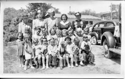 Unidentified group of Kindergarten age girls and boys with five women standing behind them, about 1940