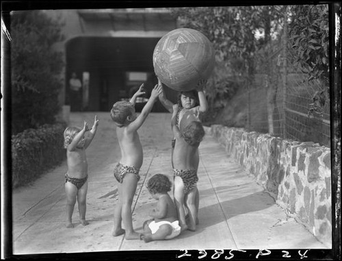 Five Estes children playing with exercise ball in a yard, [Van Nuys?], between 1928 and 1936