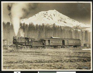 Locomotive train billowing steam, showing Mount Shasta in the background, Siskiyou County, ca.1900