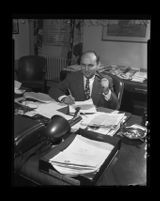 Pacific Colony mental hospital superintendant, Dr. George Tarjan, at his desk, 1950