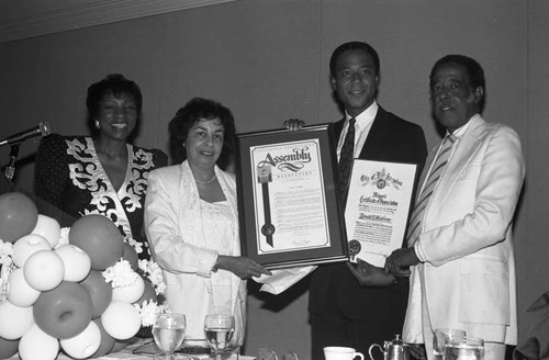 Teresa Hughes presenting an award to Ronald Claiborne, Los Angeles, 1989