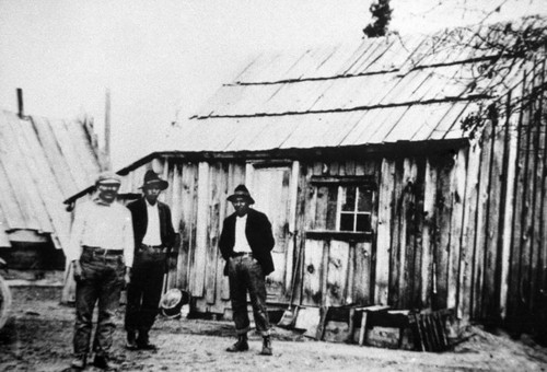 Three men in front of Shasta County homes
