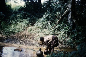 Woman collecting water, Bankim, Adamaoua, Cameroon, 1953-1968