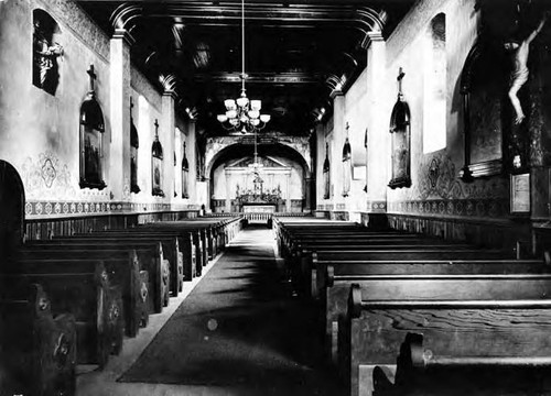 Long interior shot of Plaza Church showing pews, altar and side walls