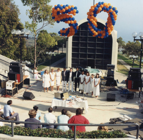 Choral group performing in amphitheater during 50th anniversary celebrations, 1987