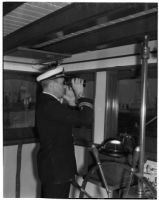 Captain Lars H. Weseth looking through binoculars, Los Angeles, May 23, 1940