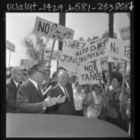 Governor Edmund G. (Pat) Brown and Supervisor Ernest Debs surrounded by Anti-Poverty protesters in Los Angeles, Calif., 1966