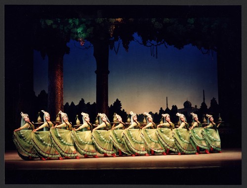 12 Chinese women each holding a tray with carafe while dancing a Persian wine dance /