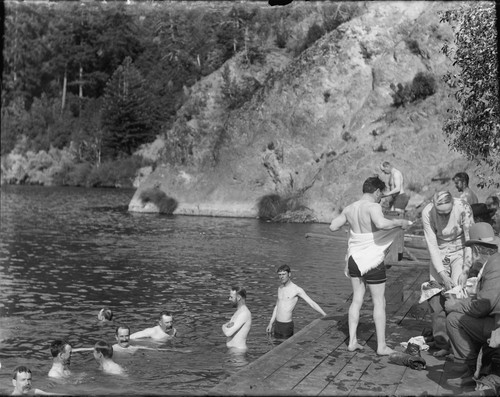 Men swimming and on platform, Bohemian Grove. [negative]