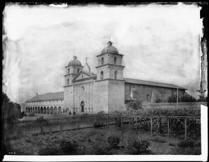 Mission Santa Barbara, showing main front of church from vineyard, California, 1898