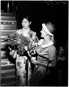 Miss Japan arrival at airport, 1958