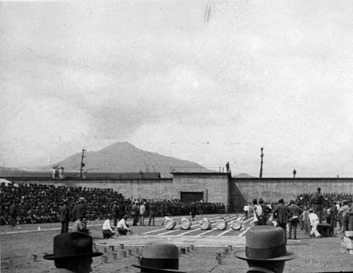 Officials viewing the obstacle race, San Quentin Little Olympics Field Meet, 1930. Mt. Tamalpais in the distance [photograph]