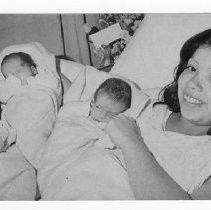 Sally Hinojosa [of Lodi] beams while holding her newborn triplets. Headline: "Think I'm Going To Have A Baby"--3 Born
