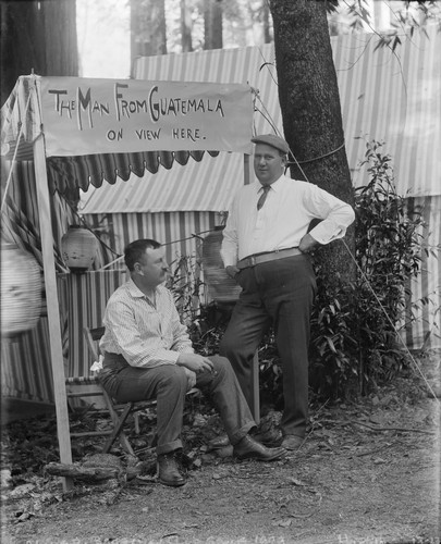 Two men, one identified as Hopkins, by sign "The man from Guatemala on view here," Bohemian Grove. [negative]