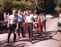 Firemen pulling a hose cart in Mill Valley's 75th Anniversary parade, 1975