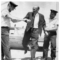 "Clean Cut Caper": Alan Cranston, center, California State Controller, and candidate for US Senate shown "handled" by two Vacaville, CA firemen during Vacaville's "Fiesta Days" for being clean shaven. Firemen are, Clarence E. McDaniel on the left and Don A. Barty on the right