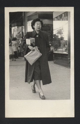 Photograph of Suzuki family member walking down the street