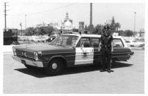 Police officer with patrol car 186