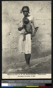 Woman carrying a child, Cameroon, ca.1920-1940
