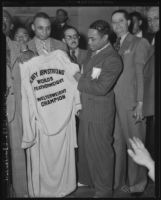 Henry Armstrong poses with World Featherweight Welterweight Champion robe