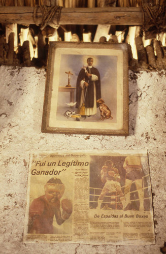 Pictures hanging from a wall, San Basilio de Palenque, 1976