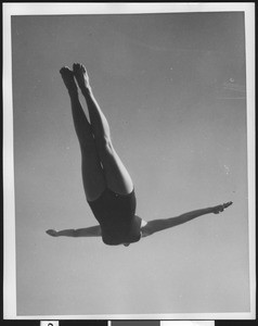 Female diver in the middle of her dive, ca.1930