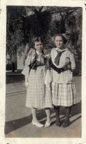 Two girls in plaid school uniform