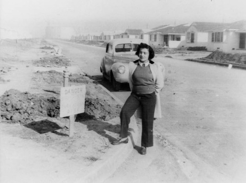 Woman on street of new homes