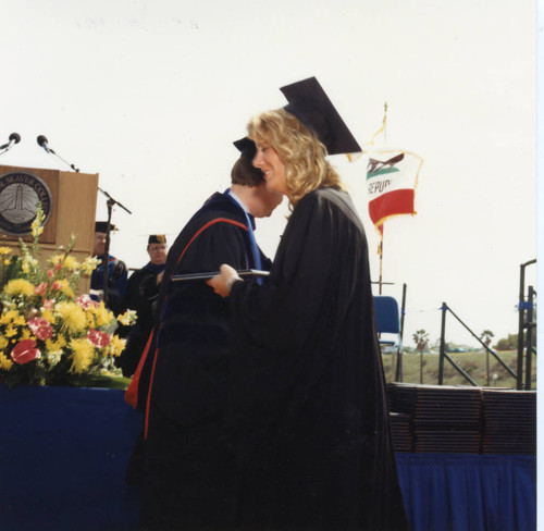 President Davenport presenting a diploma to a lady student