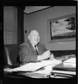 Portrait of executive seated at desk