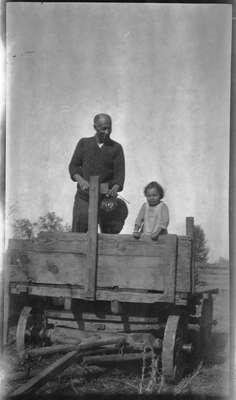 Frederick M. Roberts and Gloria Pearl Roberts riding in wagon cart