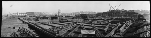 [Construction view of Panama-Pacific International Exposition site, with extensive stacks of lumber, looking south toward Pacific Heights.]