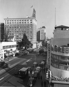 A high-angle view of Hollywood Boulevard from the intersection of Cahuenga Boulevard which foregrounds the Owl Drug Company