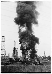 Oil fire at an unidentified oil field, showing a column of smoke